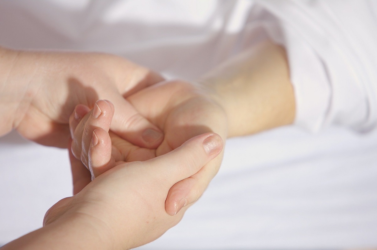 Korean Hand Therapy - Close-up of practitioner working on specific pressure points on client's hand