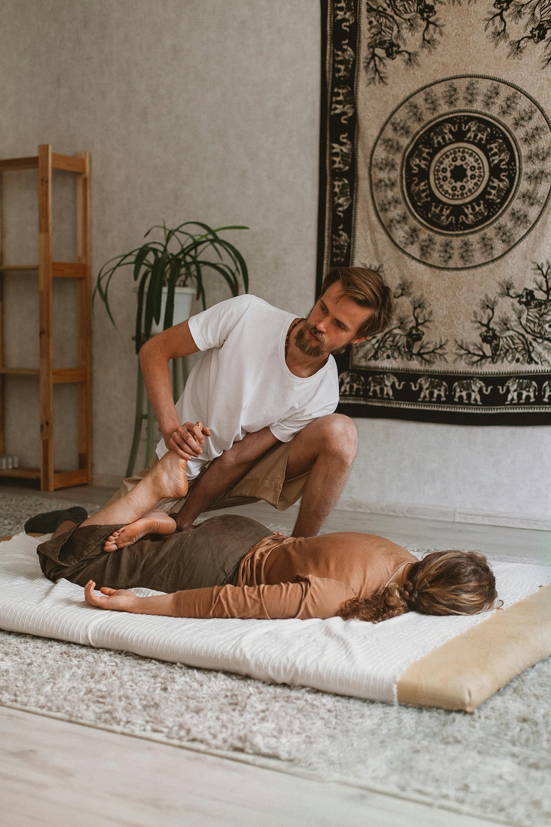 Traditional Thai Massage - Practitioner performing stretching techniques